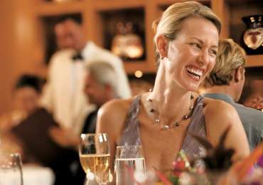 Guest enjoying fine dining aboard luxury South Pacific cruise in the Cook Islands and Society Islands