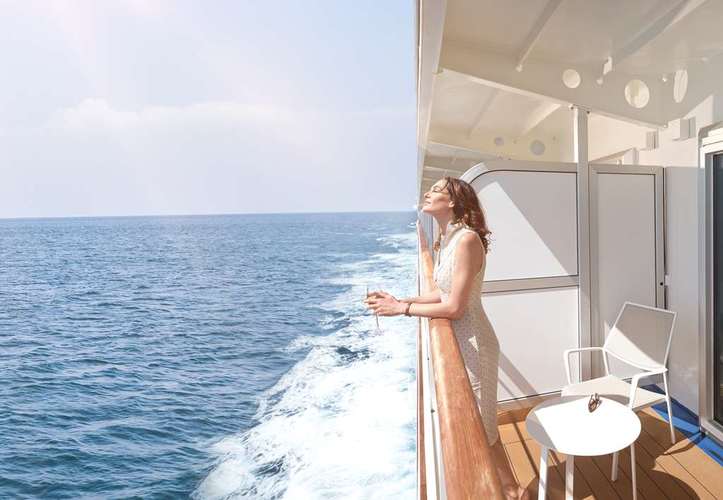 Guest relaxing on private veranda balcony aboard Seabourn Quest Caribbean cruise
