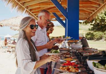 Windstar Cruises guests enjoying private beach barbecue in Bora Bora during Tahiti small ship cruise